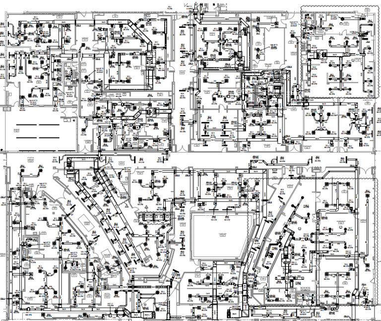 Black and white technical drawing of a building floor plan with detailed architectural and engineering symbols, labels, and measurements covering multiple rooms and sections—ideal for design build projects seeking clear coordination between design and construction phases.